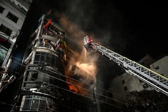 Firefighters work to extinguish a fire in a commercial building that killed at least 43 people, in Dhaka, on February 29, 2024. At least 43 people were killed and dozens injured after a fire blazed through a seven-storey building in an upscale neighbourhood in the Bangladeshi capital of Dhaka late on February 29, health authorities said. (Photo by Munir Uz Zaman / AFP) (Photo by MUNIR UZ ZAMAN/AFP via Getty Images)