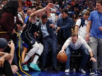DALLAS, TEXAS - OCTOBER 27: Luka Doncic #77 of the Dallas Mavericks falls into fans trying to save a loose ball against the Brooklyn Nets in the fourth quarter at American Airlines Center on October 27, 2023 in Dallas, Texas. NOTE TO USER: User expressly acknowledges and agrees that, by downloading and or using this photograph, User is consenting to the terms and conditions of the Getty Images License Agreement. (Photo by Richard Rodriguez/Getty Images)