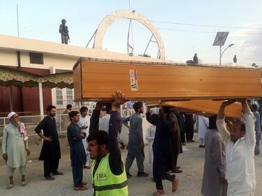 epa10777458 People shift coffins to collect bodies of victims outside a hospital following a blast targeting a gathering of Islamic political party Jamiat Ulma-e-Islam (JUI-F) in Bajaur, Pakistan, 30 July 2023. At least 20 people were killed and several injured in an explosion at the JUI-F workers convention in Khar, police said.  EPA/HANIFULLAH KHAN