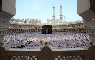 Muslims perform the morning prayer around the Kaaba at the Grand Mosque in Saudi Arabia's holy city of Mecca at the start of Eid al-Fitr, which marks the end of the Muslim holy fasting month of Ramadan, early on March 30, 2025. (Photo by Abdel Ghani BASHIR / AFP)