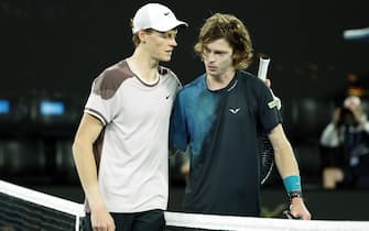 epa11098809 Jannik Sinner of Italy (L) shakes hands with Andrey Rublev of Russia (R) after winning his quarterfinal match at the Australian Open tennis tournament in Melbourne, Australia, 23 January 2024.  EPA/MAST IRHAM
