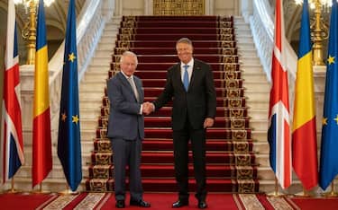 Britain's King Charles III (L) is welcomed by Romanian President Klaus Iohannis at the Cotroceni Presidential Palace in Bucharest, on June 2, 2023. Britain's King Charles III was received with military honours at Romania's presidential palace in Bucharest on Friday, as he kicked off his solo visit in the eastern European country. Charles' trip to Romania is his first abroad since he was crowned king on May 6. (Photo by MIHAI BARBU / AFP) (Photo by MIHAI BARBU/AFP via Getty Images)