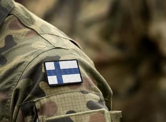 Flag of Finland on military uniform. Army, troops, soldiers. Collage.