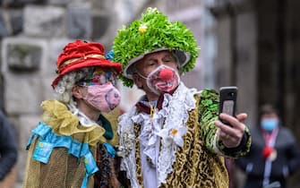 COLOGNE, GERMANY - FEBRUARY 15: A lone pair of carnival enthusiasts take a selfie on Rose Monday, the day that is normally the height of Germany's carnival season, during the second wave of the coronavirus pandemic on February 15, 2021 in Cologne, Germany. Carnival celebrations have been cancelled nationwide this year as part of ongoing lockdown measures. (Photo by Lukas Schulze/Getty Images)