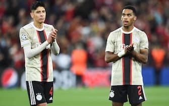 epa10182492 Edson Alvarez (L) and Jurrien Timber (R) of Ajax react after losing the UEFA Champions League group A soccer match between Liverpool FC and Ajax Amsterdam in Liverpool, Britain, 13 September 2022.  EPA/PETER POWELL