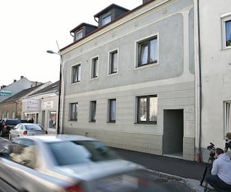 This picture taken on April 27, 2008 shows a car passing by a house in Amstetten, some 120 kilometers west of Vienna, where a 73-year-old man locked up his daughter in a basement for 24 years and fathered seven children with her. The man was arrested by the police on April 27, 2008 after his daughter was found in the house.   AFP PHOTO/DIETER NAGL (Photo credit should read DIETER NAGL/AFP via Getty Images)