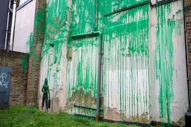 LONDON, UNITED KINGDOM - March 18: A new tree mural artwork is seen on a building that has been confirmed to be the work of the artist Banksy at Finsbury Park in London, United Kingdom on March 18, 2024. The artwork has been painted in front of a cut down tree to look like green foliage also matching the green used by Islington Council for signs. (Photo by Stringer/Anadolu via Getty Images)