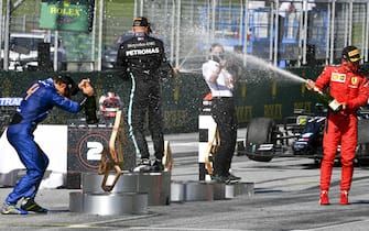 JULY 05: Lando Norris, McLaren, Race winner Valtteri Bottas, Mercedes-AMG Petronas F1 and Charles Leclerc, Ferrari celebrate on the podium with the champagne during the Austrian GP on Sunday July 05, 2020. (Photo by Mark Sutton / Sutton Images)