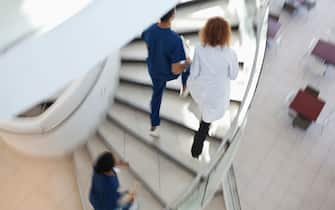 Hospital staff climbing spiral steps