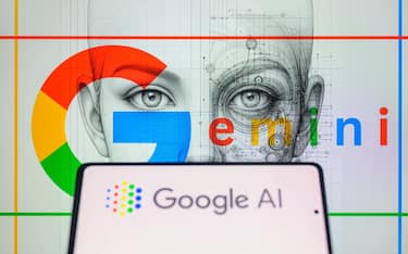 The Google AI logo is being displayed on a smartphone with Gemini in the background in this photo illustration, taken in Brussels, Belgium, on February 8, 2024. (Photo by Jonathan Raa/NurPhoto via Getty Images)