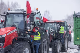 Farmers with tractors block the access to the Polish-Ukrainian border crossing in Dorohusk, eastern Poland, on February 9, 2024, during a farmers' protest across the country against EU politics and Ukrainian agricultural products allowed on EU market at low prices. (Photo by Wojtek Radwanski / AFP) (Photo by WOJTEK RADWANSKI/AFP via Getty Images)