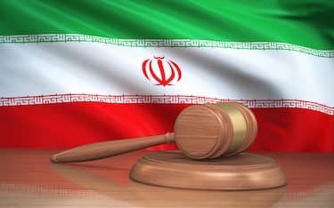 3d Render Judge Gavel and iran flag on background (close-up)