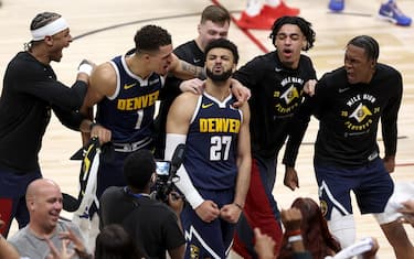 DENVER, COLORADO - APRIL 29: Jamal Murray #27 of the Denver Nuggets celebrates with his teammates after making a basket in the final seconds tom defeat the Los Angeles Lakers during game five of the Western Conference First Round Playoffs at Ball Arena on April 29, 2024 in Denver, Colorado. NOTE TO USER: User expressly acknowledges and agrees that, by downloading and or using this photograph, User is consenting to the terms and conditions of the Getty Images License Agreement.  (Photo by Matthew Stockman/Getty Images)