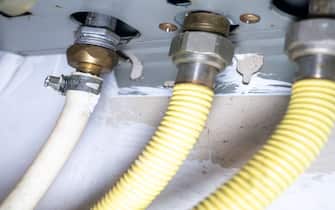 Part of gas equipment. Hoses in a gas water heater. Gas flows through these pipes at home. Hoses are connected to the device