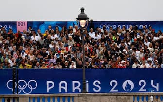 epa11497519 Spectators wait for the Opening Ceremony of the Paris 2024 Olympic Games, in Paris, France, 26 July 2024.  EPA/MOHAMMED BADRA