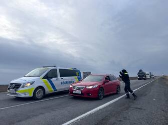 GRINDAVIK, ICELAND - NOVEMBER 14: Police direct traffic out of Grindavik on November 14, 2023 in Grindavik, Iceland.  For the second day residents were allowed in to quickly collect personal belongings. (Photo by Micah Garen/Getty Images)