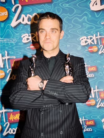 Robbie Williams poses with the British Single of the Year and British Video of the Year awards backstage during The 20th BRIT Awards with Mastercard, Earls Court Exhibition Centre, London, UK, Friday 03 Mar 2000
Photo JM Enternational