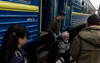 POKROVSK, UKRAINE - MAY 1: Volunteers and emergency workers evacuate a person with reduced mobility onto a train in the direction of Lviv, at Pokrovsk train station, Ukraine on May 01, 2023. (Photo by Diego Herrera Carcedo/Anadolu Agency via Getty Images)