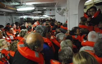 A photo taken by Spanish passenger Carlos Carballa on board cruise boat Costa Concordia and released on 15 January 2012 shows passengers waiting to be evacuated after the ship run aground off Italian island Giglio's coast late 13 January 2012.       ANSA/CARLOS CARBALLA