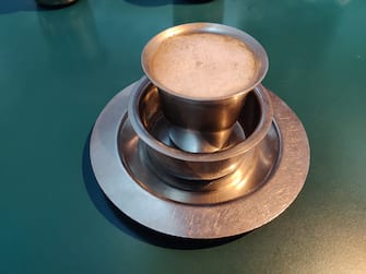 CHENNAI, INDIA. Filter coffee or brewed coffee, a special South Indian blend of coffee in unique steel tumblers. This very strong coffee has a mix of Chicory and is brewed overnight to get the right flavour. Called Filter Coffee because the brew is filtered and the strong decoction is then mixed with sugar and milk and served in steel tumblers with a gentle froth. The taste is divine for the cannousiers. Photo by Pallava Bagla for Getty Images