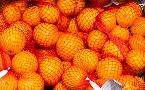 A crate of oranges on sale in a UK supermarket.