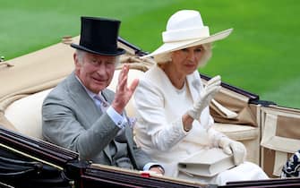 ASCOT, ENGLAND - JUNE 20: King Charles III and Queen Camilla salute the crowds on day one during Royal Ascot 2023 at Ascot Racecourse on June 20, 2023 in Ascot, England. (Photo by Tom Dulat/Getty Images for Ascot Racecourse)