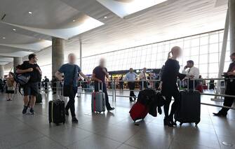 Travelers walk through International Terminal Four at John F. Kennedy International Airport in Queens, New York, USA, 30 June 2017. ANSA/PETER FOLEY