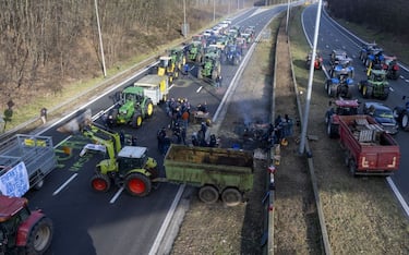 Tractors blocking the E19 highway at the E429 crossing pictured during a farmers protest in Halle (Hal), organised by the federation of young walloon farmers (FJA), Monday 29 January 2024. Farmers protests across Europe are growing as they demand better conditions to grow produce and maintain a proper income. BELGA PHOTO NICOLAS MAETERLINCK (Photo by NICOLAS MAETERLINCK / BELGA MAG / Belga via AFP) (Photo by NICOLAS MAETERLINCK/BELGA MAG/AFP via Getty Images)