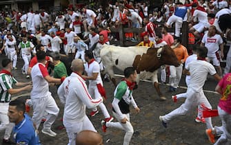 PAMPLONA, SPAIN - JULY 09: People take part in the traditional 'encierro' (bull-run) on the third day of the of the San Fermin Festival in Pamplona, Spain on July 09, 2023. The bull-running fiesta is held annually from 06 to 14 July in commemoration of the city's patron saint. Visitors from all over the world attend the festival. Many of them physically participate in the highlight event - the running of the bulls, or encierro - where they attempt to outrun the animals along a route through the narrow streets of Pamplona's old city. (Photo by Burak Akbulut/Anadolu Agency via Getty Images)