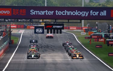 SHANGHAI INTERNATIONAL CIRCUIT, CHINA - APRIL 20: Lando Norris, McLaren MCL38, and Fernando Alonso, Aston Martin AMR24, prepare to lead the field away for the start of the Sprint during the Chinese GP at Shanghai International Circuit on Saturday April 20, 2024 in Shanghai, China. (Photo by Zak Mauger / LAT Images)