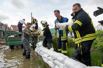 02 June 2024, Bavaria, Gundelfingen: Soldiers from the German Armed Forces build a barrier of sandbags together with civilian firefighters. The district of Dillingen asked the Bundeswehr for support in combating the floods. Photo: Stefan Puchner/dpa (Photo by Stefan Puchner/picture alliance via Getty Images)