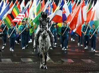 PARIS, FRANCE - JULY 26:  Floriane Issert, a Gendarmerie non-commissioned officer of the National Gendarmerie, carries the Olympic flag as she rides on the Iena bridge during the Opening Ceremony of the Olympic Games Paris 2024 on July 26, 2024 in Paris, France. (Photo by Stephanie Lecocq - Pool/Getty Images)