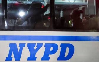 epa11311448 People wait on a police bus after being arrested by New York City police officers after entering Hamilton Hall at Columbia University after pro-Palestinian protestors barricaded themselves in the building earlier in the day in New York, New York, USA, 30 April 2024. Students have been protesting the university's investments in Israel and showing their support for Palestine for over two weeks, also inspiring other students nationwide to do the same.  EPA/STEPHANI SPINDEL