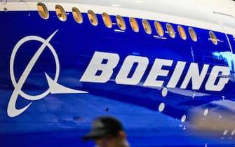 epa08967893 (FILE) - A file photo dated 14 June 2016 showing a man walking past a logo of US aircraft manufacturing company Boeing at Taoyuan airport, in Taoyuan, Taiwan (reissued 26 January 2021). Boeing is due to release its 4th quarter 2020 results on 27 January 2021.  EPA/RITCHIE B. TONGO *** Local Caption *** 56030419