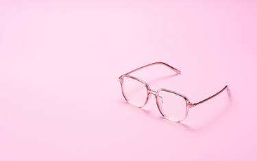 Fashionable Trendy Pink Colored Eyeglasses Side View on Pink Background With Copy Space.