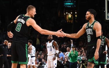 BOSTON, MA - MARCH 1: Jayson Tatum #0 and Kristaps Porzingis #8 high five during the game against the Dallas Mavericks on March 1, 2024 at the TD Garden in Boston, Massachusetts. NOTE TO USER: User expressly acknowledges and agrees that, by downloading and or using this photograph, User is consenting to the terms and conditions of the Getty Images License Agreement. Mandatory Copyright Notice: Copyright 2024 NBAE  (Photo by Brian Babineau/NBAE via Getty Images)