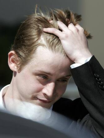 SANTA MARIA, UNITED STATES:  US actor Macaulay Culkin leaves Santa Barbara County Superior Court in Santa Maria, CA, 11 May 2005  after testifying in US pop star Michael Jackon's child molestation trial.  Culkin denied he had been molested, saying the accusations against the pop star were "absolutely ridiculous."  AFP PHOTO / Robyn BECK  (Photo credit should read ROBYN BECK/AFP via Getty Images)