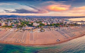 Impressive summer view from flying drone of Libera Rimini public beach. Wonderful summer scene of Italy, Europe. Superb evening view of Adriatic coast. Traveling concept background.