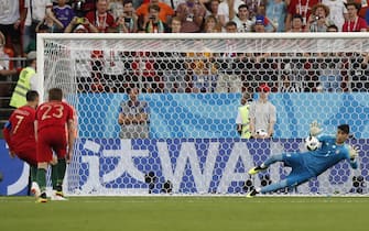 epa06840161 Goalkeeper Ali Beiranvand of Iran saves a penalty of Cristiano Ronaldo (L) during the FIFA World Cup 2018 group B preliminary round soccer match between Iran and Portugal in Saransk, Russia, 25 June 2018.

(RESTRICTIONS APPLY: Editorial Use Only, not used in association with any commercial entity - Images must not be used in any form of alert service or push service of any kind including via mobile alert services, downloads to mobile devices or MMS messaging - Images must appear as still images and must not emulate match action video footage - No alteration is made to, and no text or image is superimposed over, any published image which: (a) intentionally obscures or removes a sponsor identification image; or (b) adds or overlays the commercial identification of any third party which is not officially associated with the FIFA World Cup).  EPA/RUNGROJ YONGRIT   EDITORIAL USE ONLY