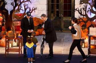 WASHINGTON, DC - OCTOBER 30: U.S. President Joe Biden (L) greets Secretary of State Antony Blinken, his wife White House Cabinet Secretary Evan Ryan and their children during a Halloween trick-or-treat event on the South Lawn of the White House on October 30, 2023 in Washington, DC. The President and first lady hosted children from local neighborhoods, public schools and military families for the annual trick-or-treating event. (Photo by Anna Moneymaker/Getty Images)