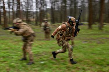 epa10582177 Members of the newly formed 'Spartan' brigade take part in military training on a shooting range near Kharkiv, northeastern Ukraine, 20 April 2023, amid the Russian invasion. In February of 2023, Ukraine's Ministry of Internal Affairs launched the 'Offensive Guard' project with the aim to establish eight volunteer assault brigades by April 2023. Russian troops entered Ukrainian territory on 24 February 2022, starting a conflict that has provoked destruction and a humanitarian crisis.  EPA/SERGEY KOZLOV