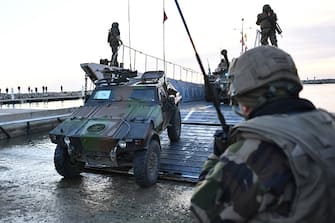 French soldiers unload a VBL armoured vehicle from a naval transport ship during a large-scale military exercise called "Orion", in Frontignan, southern France, on February 26, 2023. (Photo by Sylvain THOMAS / AFP) (Photo by SYLVAIN THOMAS/AFP via Getty Images)