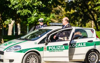 "Milan, Italy  - October 20, 2012: Italian Policemen and Police Car in Milan, Italy"
