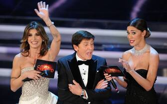Gianni Morandi with Elisabetta Canalis and Belen Rodriguez on the stage of the Ariston theater during the first evening of the Sanremo festival, 14 February 2012. ANSA /CLAUDIO ONORATI 