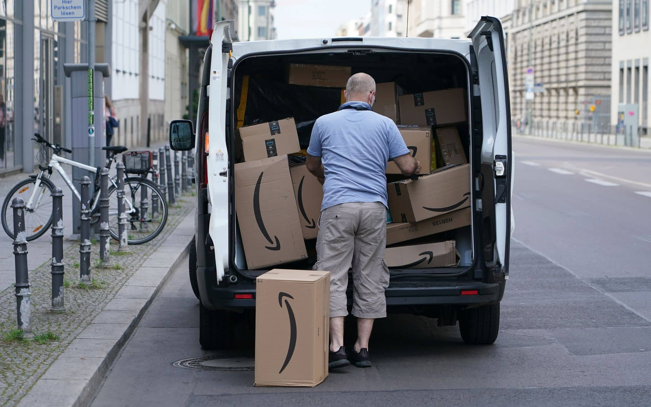 BERLIN, GERMANY - JUNE 18: A courier unloads Amazon packages during a delivery on June 18, 2020 in Berlin, Germany. Amazon has expanded rapidly in Germany and now has at least 13 Amazon warehouses nationwide.  (Photo by Sean Gallup/Getty Images)