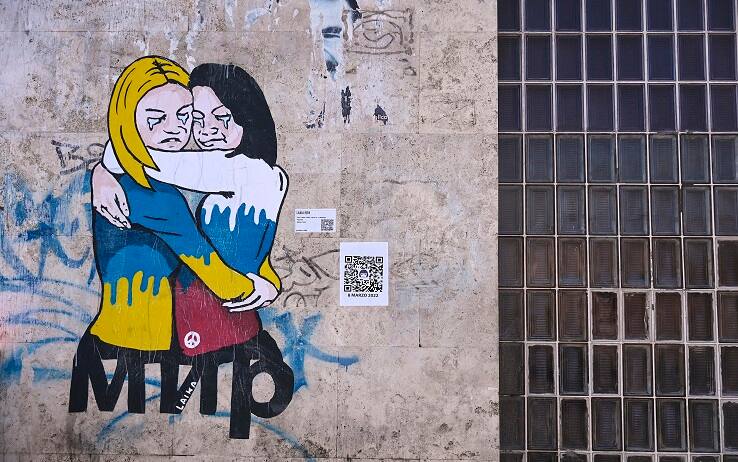 A mural by Italian street artist alias ÔLaikaÕ, depicting a hug between a Russian and a Ukrainian women against the war in Uklraine, is seen on the occasion of the International WomenÕs Day in Rome, Italy, 8 March 2022. ANSA/RICCARDO ANTIMIANI