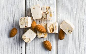 white nougat with almonds on wooden table