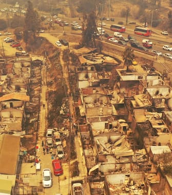 Aerial view of burned houses after a forest fire that affected the hills in Quilpe, ViÃ±a del Mar, Chile, taken on February 3, 2024. The region of Valparaoso and ViÃ±a del Mar, in central Chile, woke up on Saturday with a partial curfew to allow the movement of evacuees and the transfer of emergency equipment in the midst of a series of unprecedented fires, authorities reported. (Photo by RODRIGO ARANGUA / AFP) (Photo by RODRIGO ARANGUA/AFP via Getty Images)
