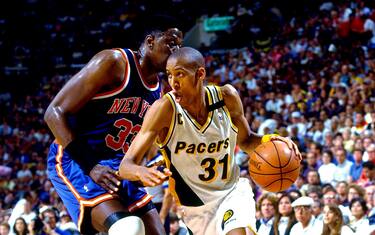 INDIANAPOLIS - MAY 28:  Reggie Miller #31 of the New York Knicks moves the ball against Patrick Ewing #33 of the New York Knicks in Game Three of the Eastern Conference Finals during the 1994 NBA Playoffs at Market Square Arena on May 28, 1994 in Indianapolis, Indiana.  The The Pacers won 88-68.  NOTE TO USER: User expressly acknowledges that, by downloading and or using this photograph, User is consenting to the terms and conditions of the Getty Images License agreement. Mandatory Copyright Notice: Copyright 1994 NBAE (Photo by Nathaniel S. Butler/NBAE via Getty Images)