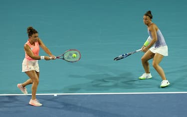 MIAMI GARDENS, FLORIDA - MARCH 29:  Jasmine Paolini of Italy returns a shot as teammate Sara Errani of Italy looks on during the Women's doubles semifinal against Bethanie Mattek-Sands and  Sofia Kenin of the United States at Hard Rock Stadium on March 29, 2024 in Miami Gardens, Florida. (Photo by Elsa/Getty Images)